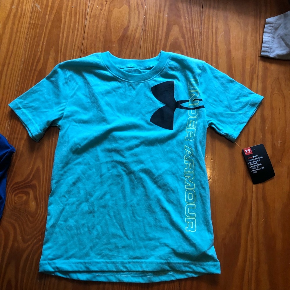 Two shirts  with tags size 6 UA boys
